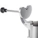 A metal Robot Coupe vegetable prep attachment with a handle on top.