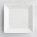 An Acopa bright white square porcelain plate on a white surface.