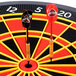 An Arachnid electronic dart board with darts in the center.
