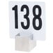 An American Metalcraft stainless steel menu / card holder with a white sign and black numbers displayed on a table.