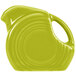 A Fiesta Lemongrass mini disc china creamer pitcher with a handle in green.