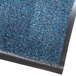 A blue Olefin entrance mat with a black border.