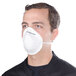 A man wearing a Cordova nuisance dust mask with a white filter.