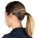 A woman wearing a white Cordova nuisance dust mask with a ponytail.