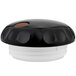 A black and white plastic container with a brown lid with a white button.