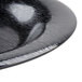 A close up of a black melamine bowl with a wavy design.