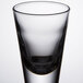 A close up of a Libbey shot glass with a black rim.