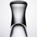 A close-up of a clear Libbey shot glass with a curved neck.