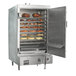 A Town stainless steel indoor smokehouse with food on shelves.