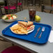 A Carlisle blue fast food tray with a sandwich and chips on it.
