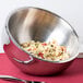 An American Metalcraft stainless steel double wall insulated bowl filled with pasta and sauce on a table.