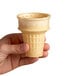 A hand holding a JOY flat bottom ice cream cone
