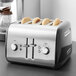 A KitchenAid Onyx Black four slice toaster with toast inside.