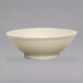 A close-up of a Tuxton eggshell white china bowl with a small rim.