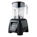 A black Waring commercial blender with a clear container.