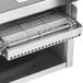 An APW Wyott conveyor toaster with a stainless steel rack over the opening.