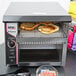 An APW Wyott conveyor toaster on a counter.