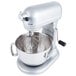 A KitchenAid stand mixer with a bowl and a KitchenAid 11-wire whisk attachment.
