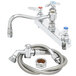 A chrome T&S deck-mounted workboard faucet with spray nozzle and hose.