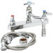 A chrome T&S deck-mounted workboard faucet with hose and shower head.