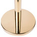 A gold metal pole with a round metal top.