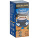 A blue box of Bigelow English Teatime Decaffeinated Tea on a table with a cup of tea.