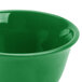 A close up of a green Thunder Group melamine bouillon cup.