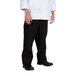 A man wearing Chef Revival black chef trousers with a white chef coat.
