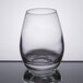 A close up of a Libbey Spirits Glass filled with a clear liquid.
