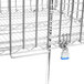 A Metro Super Erecta security module with metal wire shelves and a metal cage.