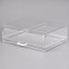 A clear plastic display case with a white handle.