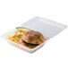 A sandwich and chips in a clear customizable reusable plastic container.