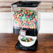 A Zevro black dry food dispenser filled with colorful cereal.
