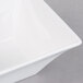 An Arcoroc white square flared bowl.