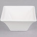 An Arcoroc white square flared bowl.