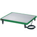 A green and white rectangular Hatco heated shelf on a table with a black cord.