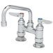 A T&S chrome deck-mount faucet with two handles and two faucets.