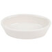 A white oval baker dish by Hall China on a white background.