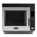 A silver and black Amana commercial microwave.