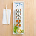 A Thunder Group Blue Bamboo melamine tray with sushi and chopsticks on it.