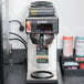 A Bunn automatic coffee brewer with upper and lower warmers on a counter.