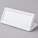 An American Metalcraft white rectangular ceramic card sign holder on a gray surface.