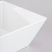 A white square Cal-Mil melamine bowl.