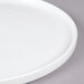 A close-up of a white Cal-Mil porcelain platter with a rim.