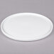 A Cal-Mil round porcelain platter with a circular rim on a gray surface.