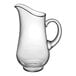 A clear glass pitcher with a handle.