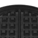 A black square non-stick waffle maker grid.