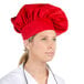 A woman wearing a red Choice chef hat.