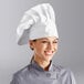 A woman wearing a white Choice chef hat.