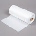 A roll of LK Packaging white disposable plastic bun pan rack covers.